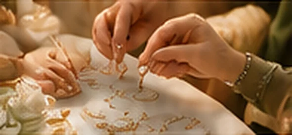 Hands arranging delicate jewellery at the Art of Heirlooms workshop